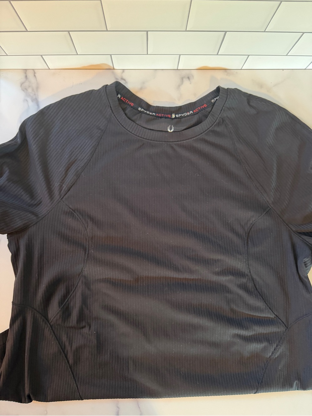 Spyder Active women’s black ribbed short sleeve performance shirt, size Large.